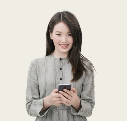 Smiling woman holding smartphone