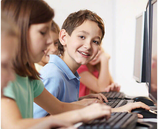 Smiling boy in computer class