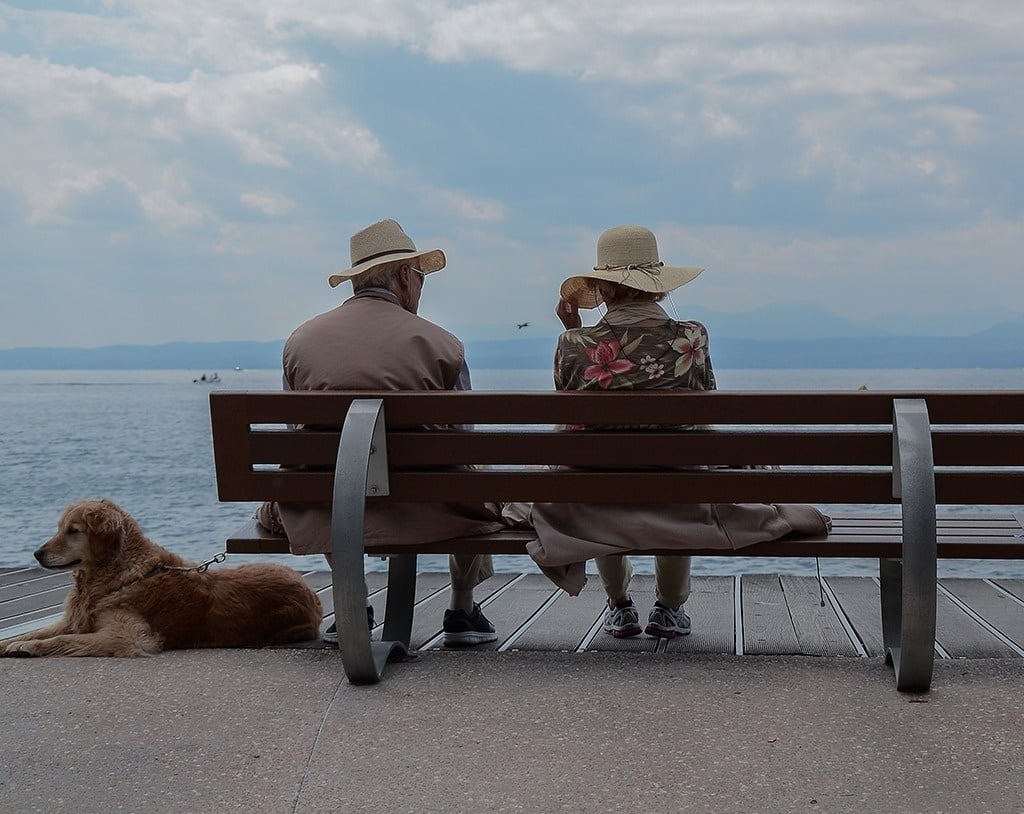 Elderly couple sitting near the sea