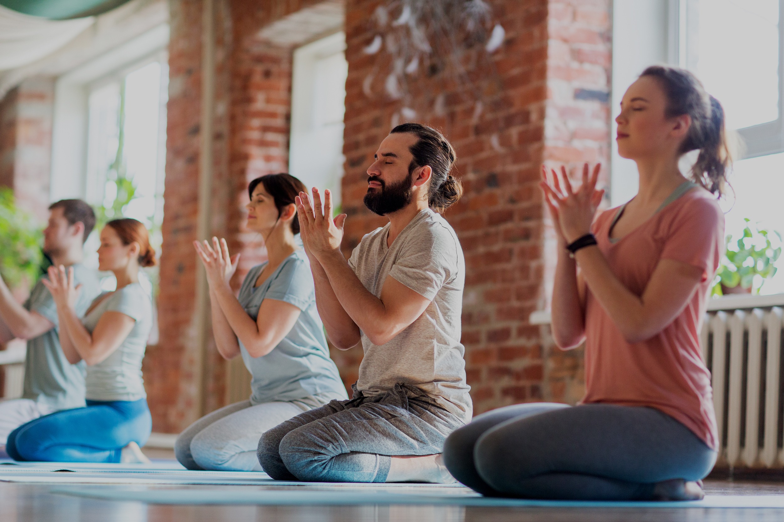 Group of people meditating at a yoga studio