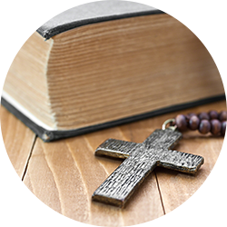 Wooden cross next to the Bible
