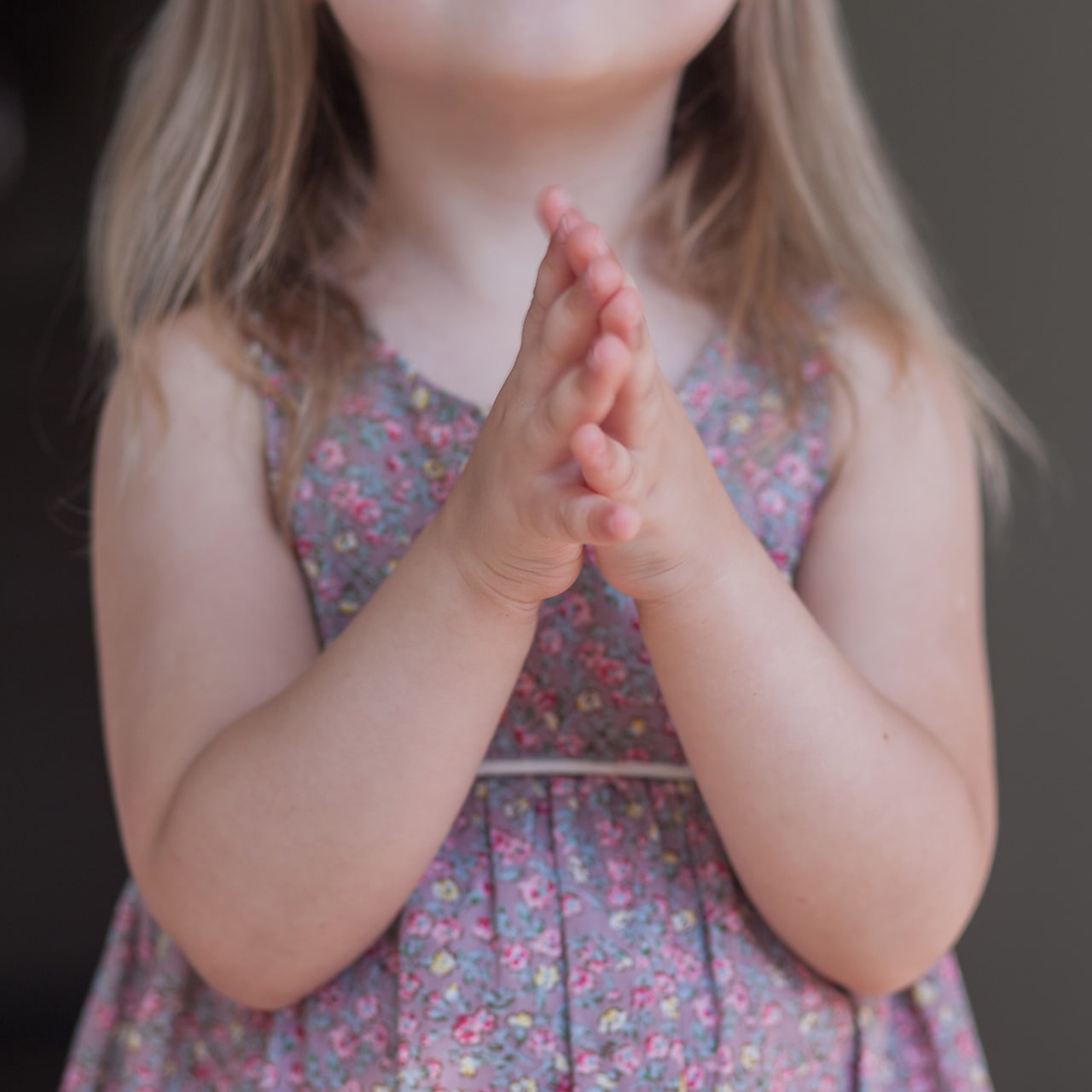 Child holding hands in prayer
