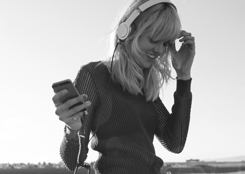 Woman with headphones listening music 
