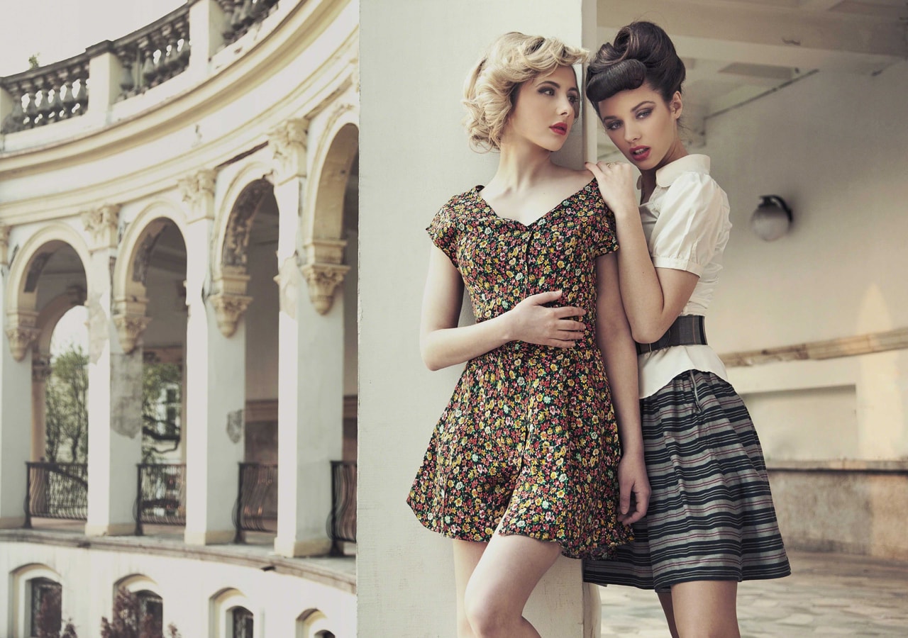 Two young women posing for a fashion photoshoot