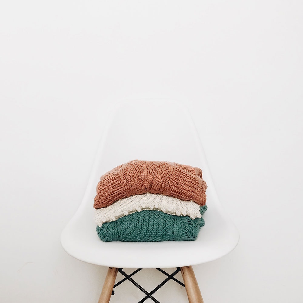 Knitted sweaters on a chair