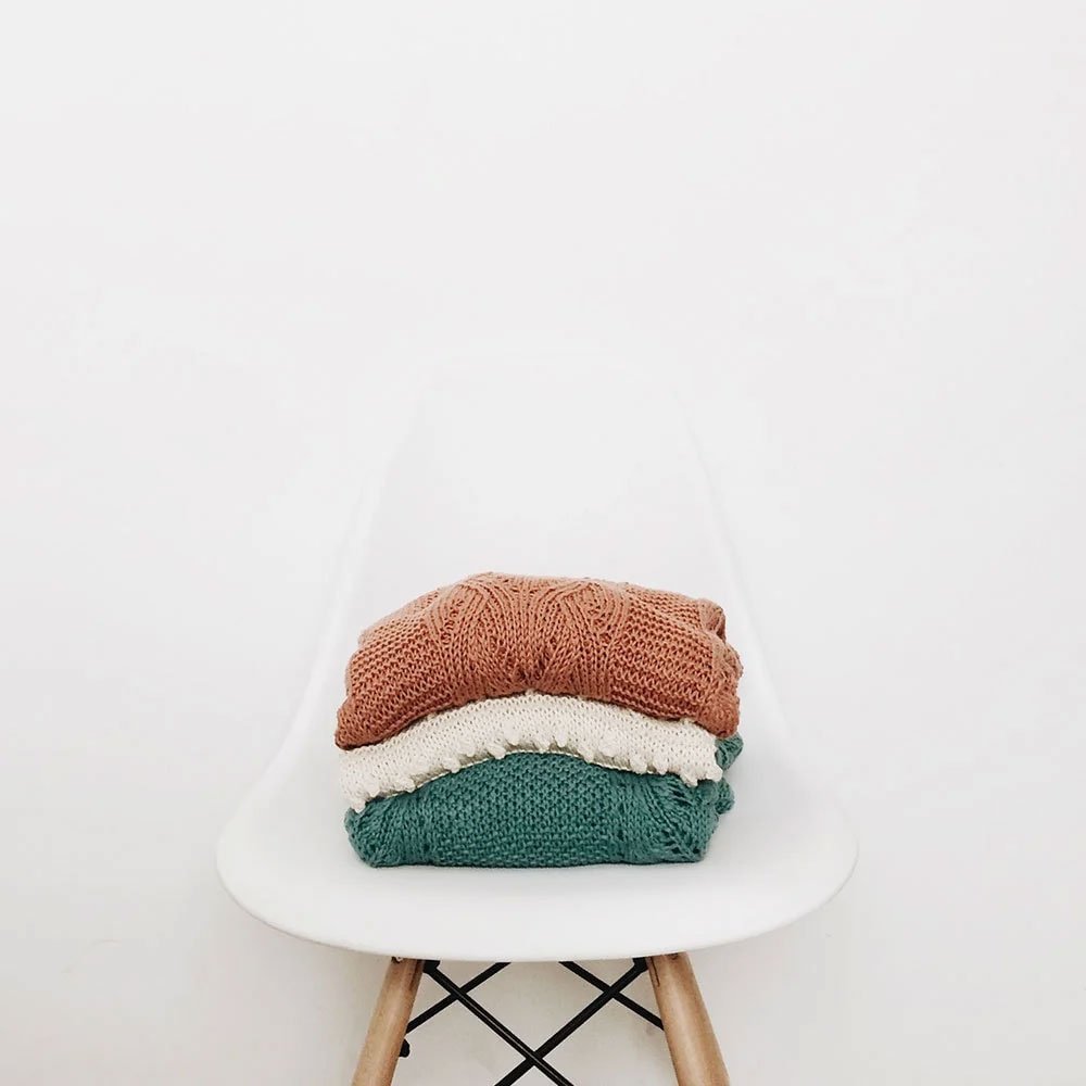 Knitted sweaters on a chair