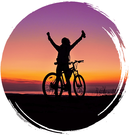Silhouette of a happy person on a bike
